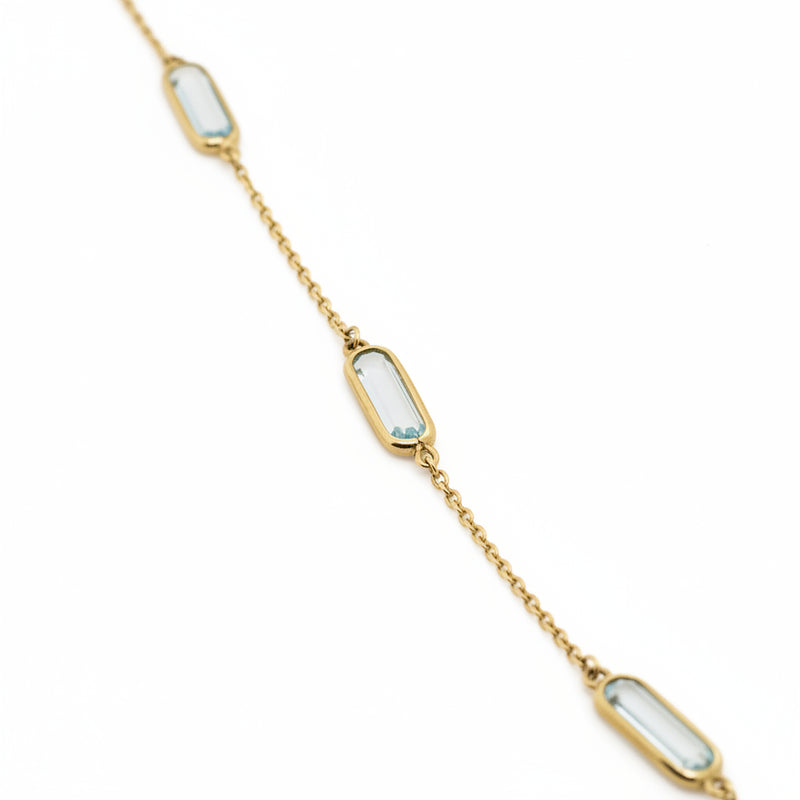 9ct Yellow Gold Bracelet with Four Oblong Blue Topaz Stations