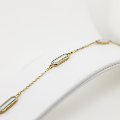 9ct Yellow Gold Bracelet with Four Oblong Blue Topaz Stations
