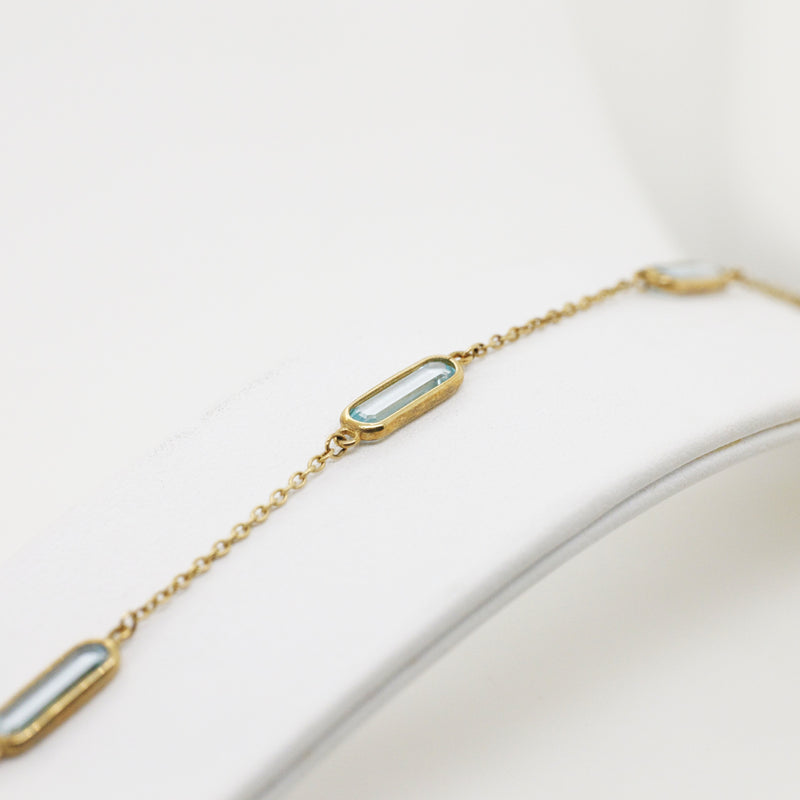 9ct Yellow Gold Bracelet with Four Oblong Blue Topaz Stations