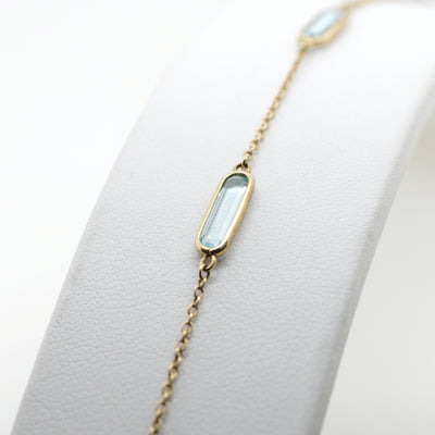 9ct Yellow Gold Bracelet with Four Oblong Blue Topaz Stations